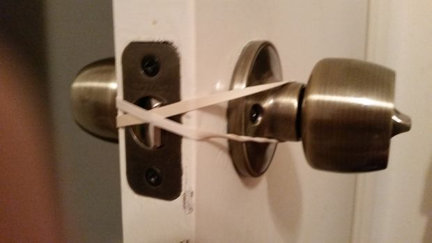 You can use rubber bands to keep the nursery room door from latching and wa